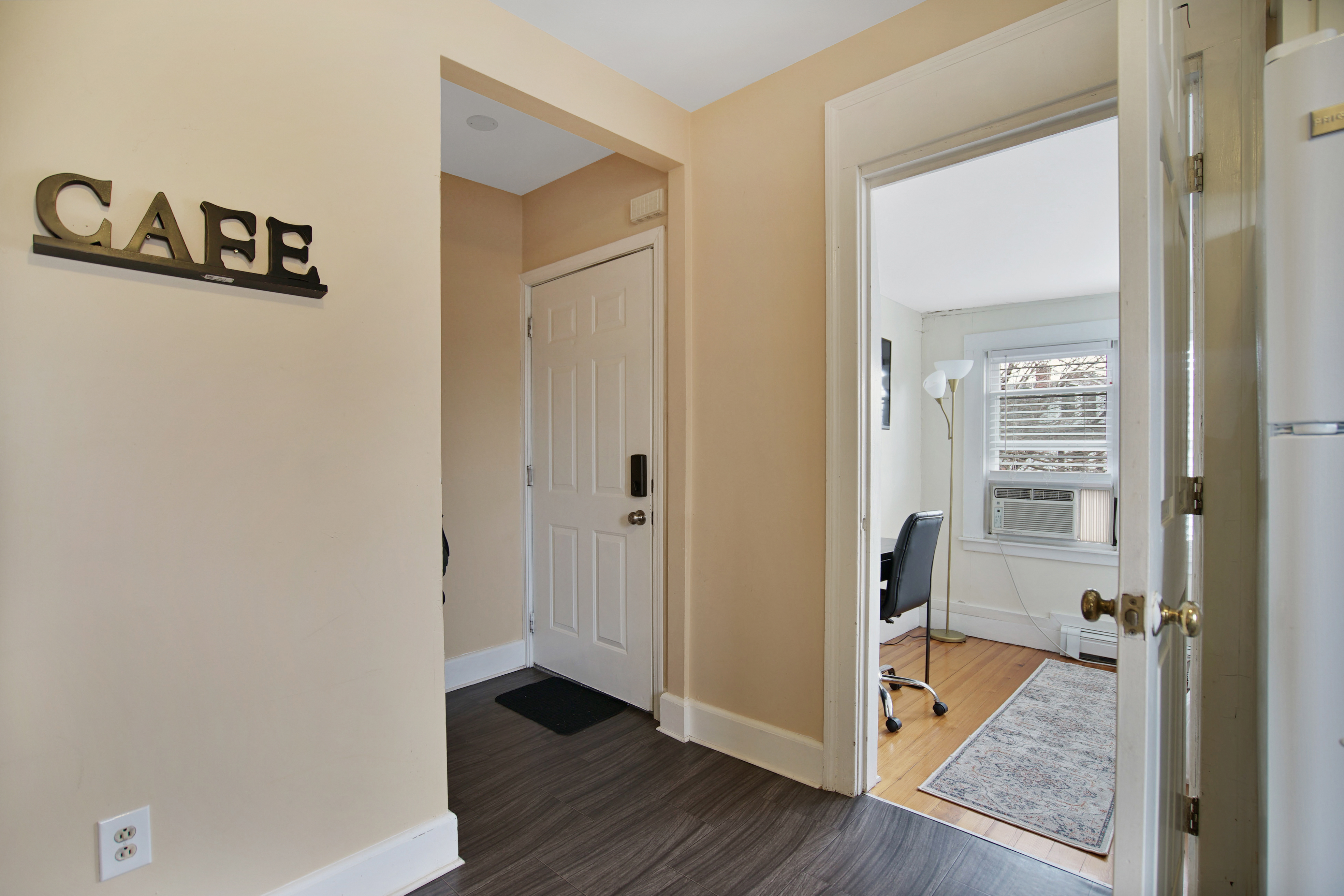 Entrance hall with CAFE sign and keypad door