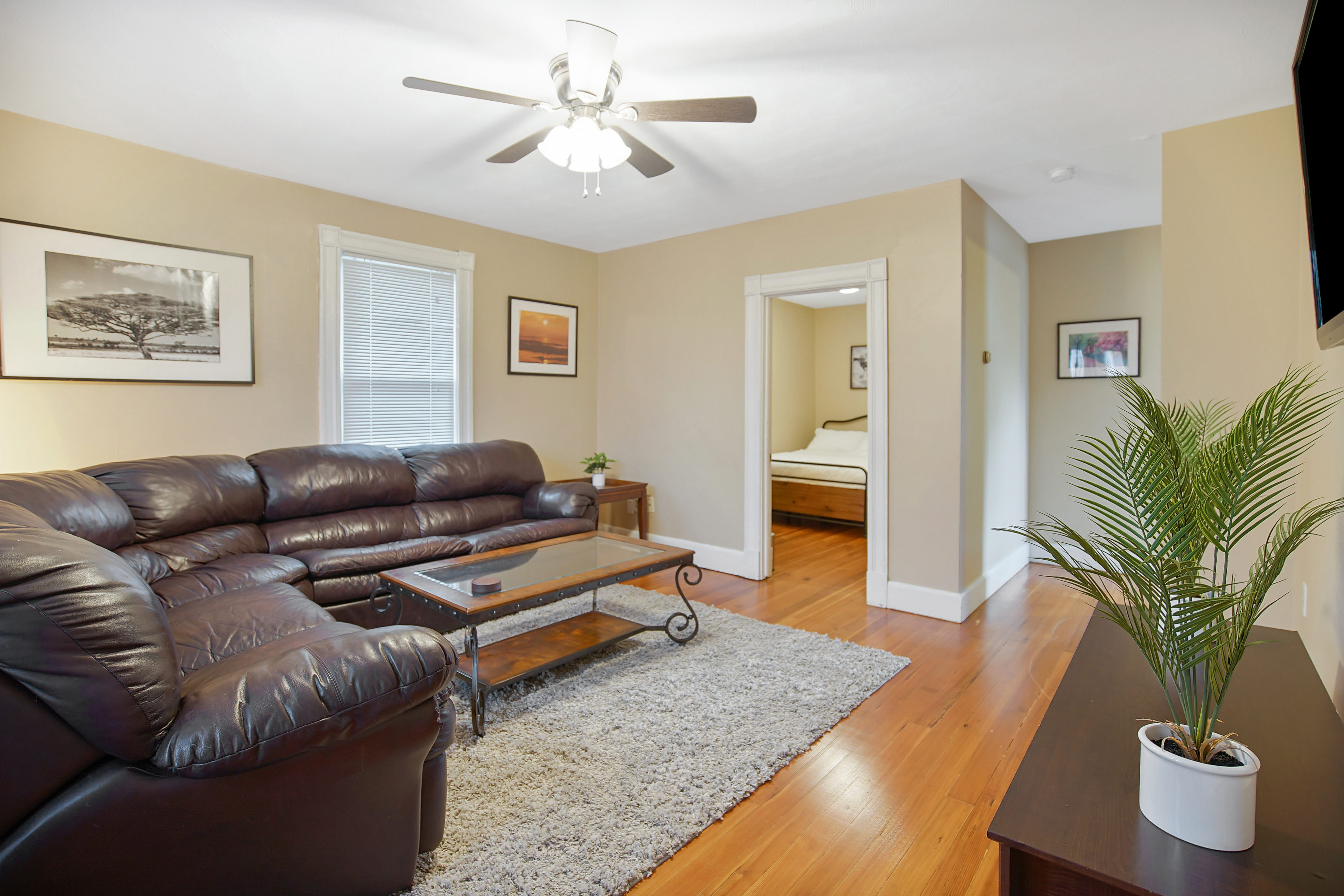 Oak Haven living room with sectional sofa and warm hardwood floors