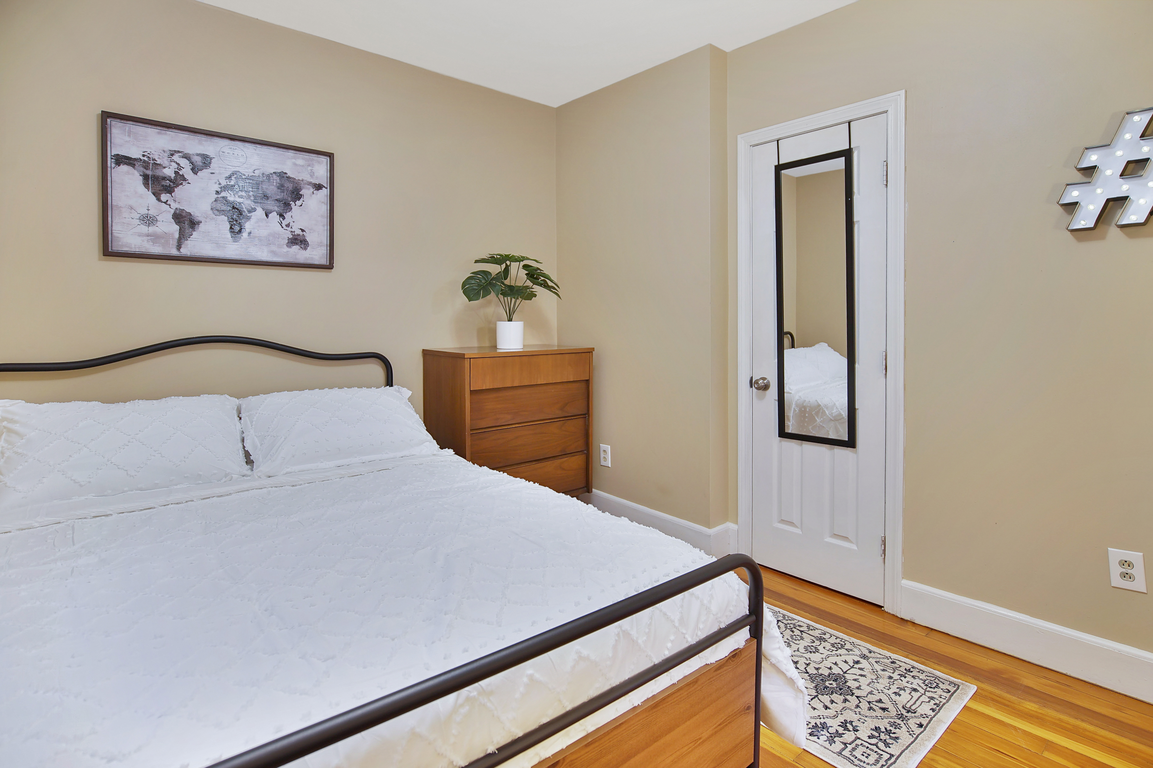 Main bedroom with king bed and world map art