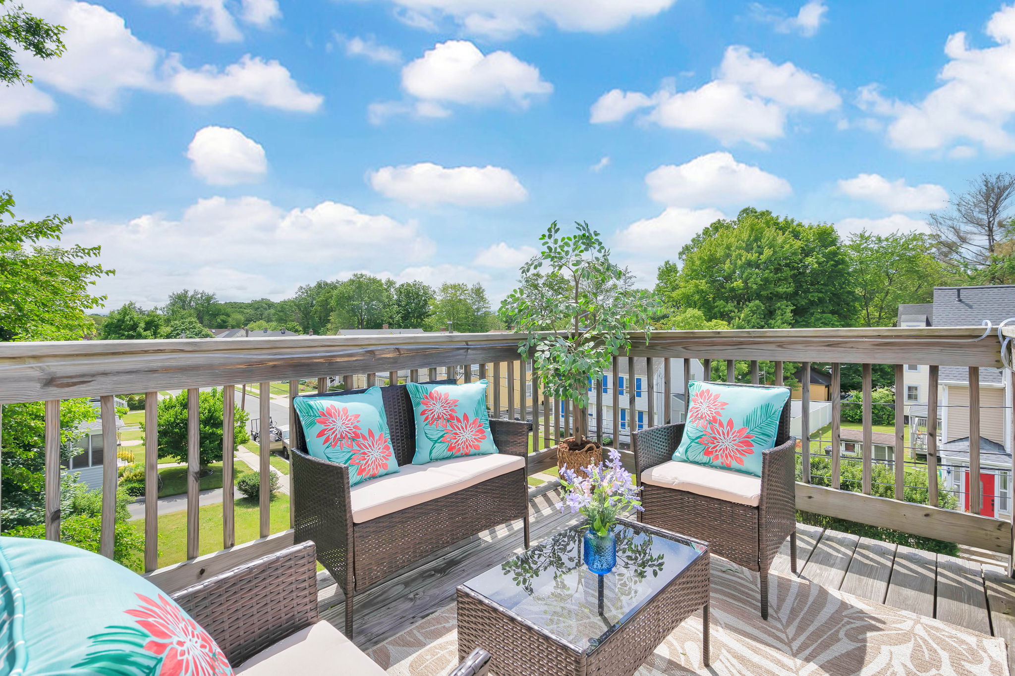 Penthouse private deck at golden hour overlooking West Hartford rooftops